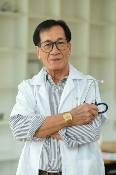 Portrait of successful and confident middle aged specialist male doctor crossed arms in white medical gown